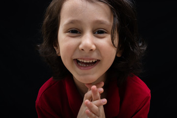 Portrait of a cute happy smiling boy in good mood