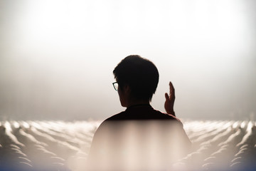 a man worships God alone in the concert hall with a smoke effect.