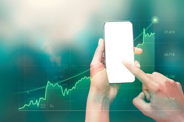 Businessman holding smartphone and showing holographic graphs and stock market statistics gain profits. Concept of growth planning good economy and business strategy. ( Clipping path screen )