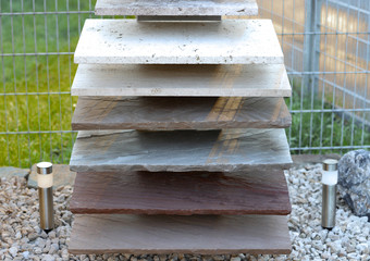 Slabs made of natural stone, in different colors and shades are on metal stands. Very practical,...