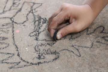 kid drawing with charcoal