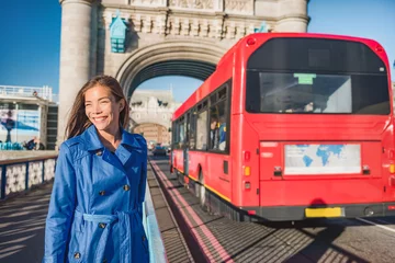 Fotobehang London woman walking commute on Tower Bridge city street using public transport bus commuting in the morning. Happy young Asian british business worker going to work or tourist city travel. © Maridav