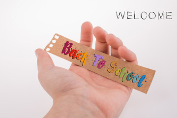 Please smile text on a piece of paper in hand