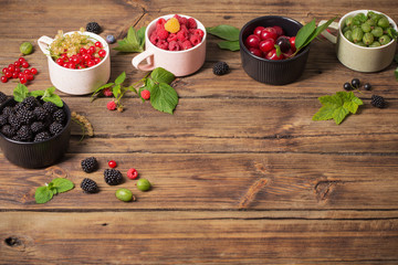 different berries on old wooden background