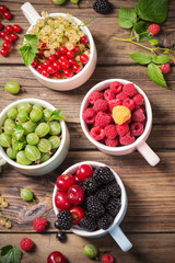different berries on old wooden background