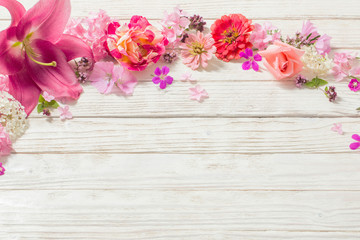 Fototapeta na wymiar pink flowers on white wooden background