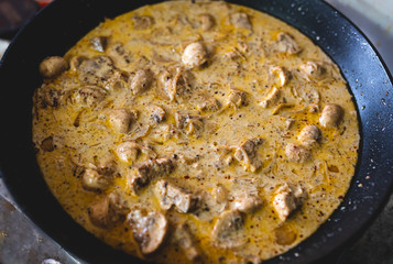 Malvani Mushroom Stroganoff Homemade indian dish in black metal pan.