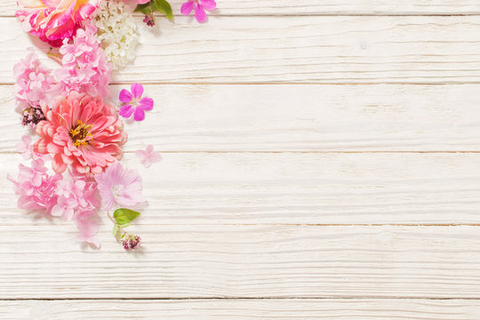 pink flowers on white wooden background