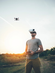 Drone pilot with virtual reality headset making photos and videos