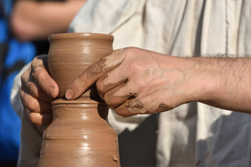 Fototapeta na wymiar Pottery male ceramist creates a hand made clay product