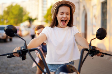 Obraz premium Couple in love riding a motorbike , Handsome guy and young sexy woman travel . Young riders enjoying themselves on trip. Adventure and vacations concept.