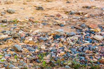Stones on the sandy shore as a background