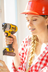 Young woman adjusting her drill doing