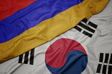 waving colorful flag of south korea and national flag of armenia.
