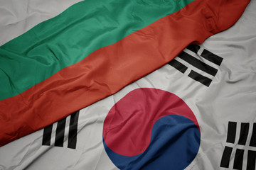 waving colorful flag of south korea and national flag of bulgaria.