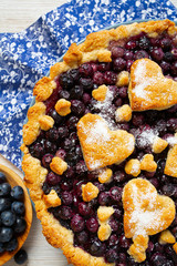 homemade blueberry pie on white wooden surface