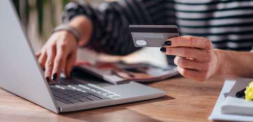 Woman shopping online and using credit card