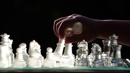 The concept of business competition: Close-up of a businessman holding a glass chess footage slow motion