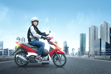 Asian motorcycle taxi man with his motorcycle on the asphalt road