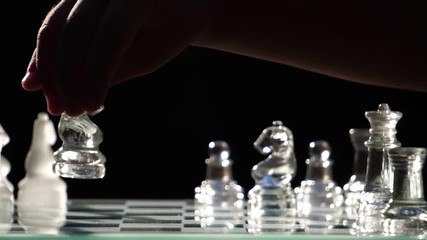 The concept of business competition: Close-up of a businessman holding a glass chess footage slow motion