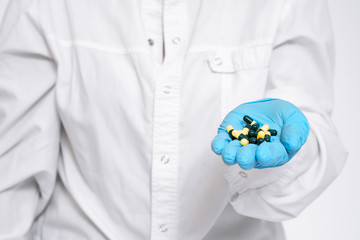 doctor holding medical drugs, pills, pills, hands with gloves. Placebo drugs concept. Treatment and health care. medicine for various diseases hospital concept.