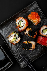 Set of sushi rolls on stone table. Top view with copy space.