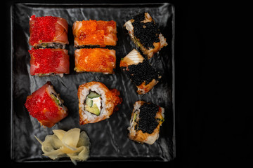 Set of sushi rolls on stone table. Top view with copy space.