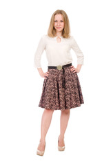 Fashion portrait of a young blonde in a skirt with hands on a belt in full growth isolated over a white