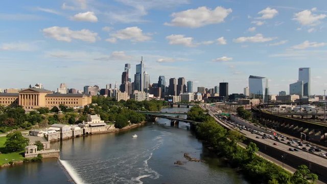 Aerial of vehicle traffic along Schuylkill River near center city Philadelphia, Pennsylvania on a sunny summer day