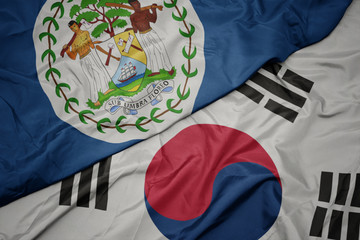 waving colorful flag of south korea and national flag of belize.