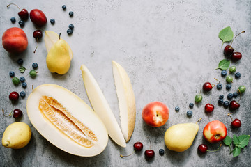 Fresh melon piece, pears and berries. Creative layout ripe fruits. Food concept