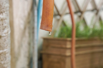 sustainable environmental save concept - water drop from plastic water tube