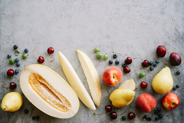 Fresh melon piece, pears and berries. Creative layout ripe fruits. Food concept