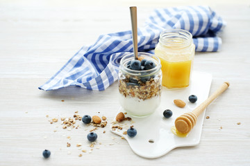 Healthy breakfast in glass jar with yogurt, muesli and blueberries. Healthy food. View from above
