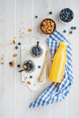 Healthy breakfast in glass jar with yogurt, muesli and blueberries. Healthy food. View from above