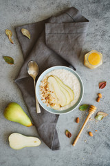 Oatmeal with slices of pear and almonds. Healthy breakfast
