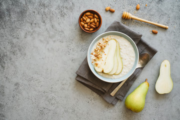 Oatmeal with slices of pear and almonds. Healthy breakfast