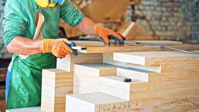 Large granite blocks. Worker at process with granite blocks