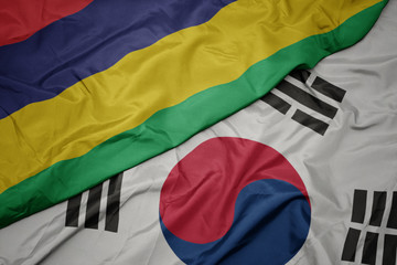 waving colorful flag of south korea and national flag of mauritius.