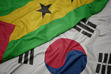 waving colorful flag of south korea and national flag of sao tome and principe .