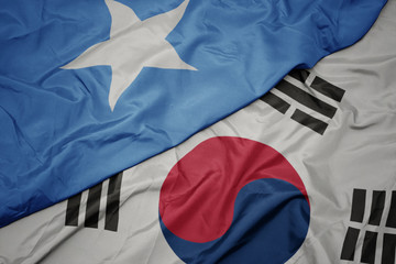 waving colorful flag of south korea and national flag of somalia.