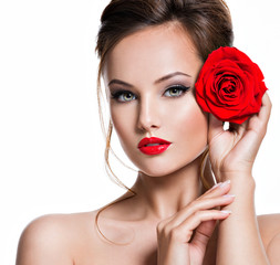 Fototapeta na wymiar Closeup face of beautiful woman with red rose bright makeup