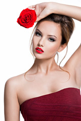 Beautiful woman with red rose in hands.