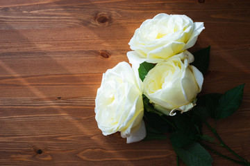 White beautiful rose flowers in a glass vase. Large rose buds with petals.
