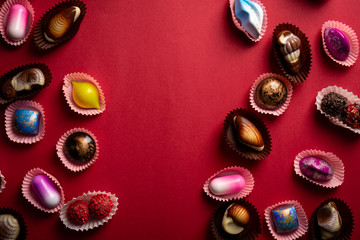 Red background with sweet chocolate bonbons set