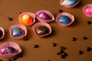Colorful background with chocolate bonbons and coffee beans