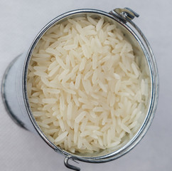 White long grain rice in a miniature metal bucket