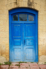 Photo of facade of old building with blue doors