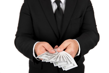 Businessman in black business suit, holding cash in hands - United stage dollar bill; clipping path - Concept of the fight against corruption - isolated on white