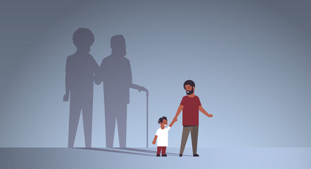 african american father with son holding hands shadow of young and mature man standing together imagination aspiration concept full length flat horizontal